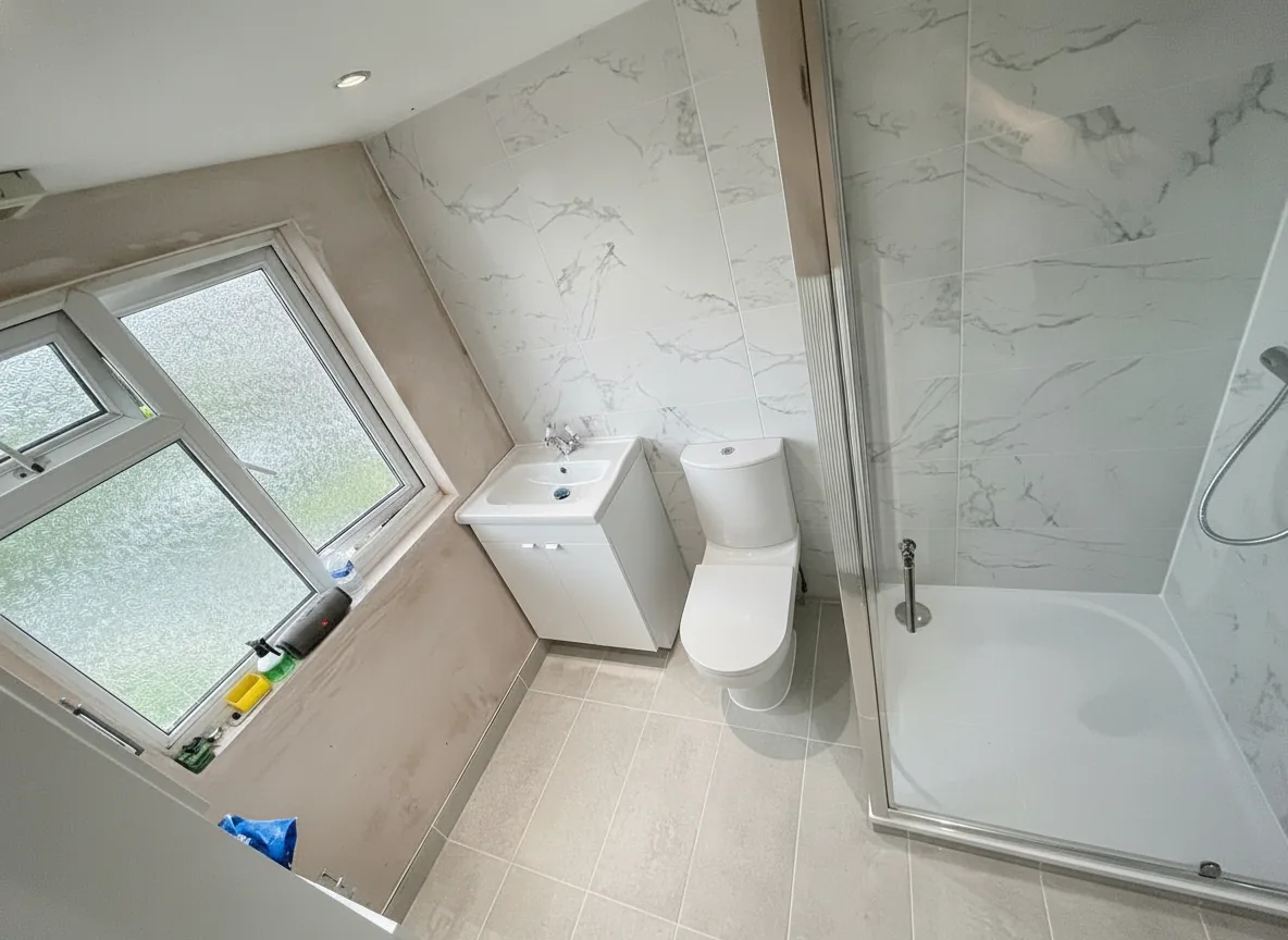 White marble-tiled shower room with corner enclosure and new sanitaryware, North London
